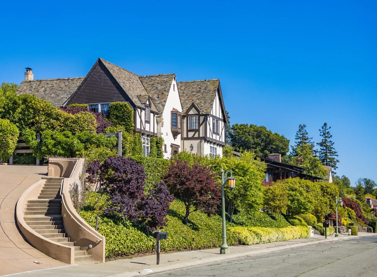 A large two-story home with landscaped grounds